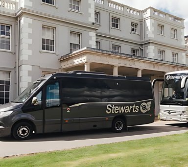 Stewarts minibus and coach outside white building