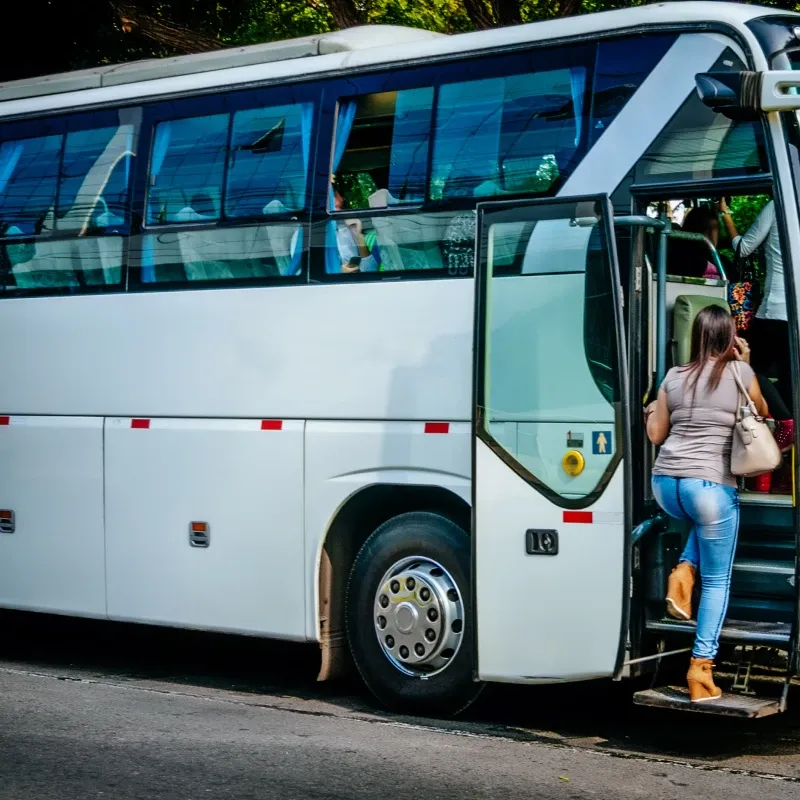 Woman boarding coach